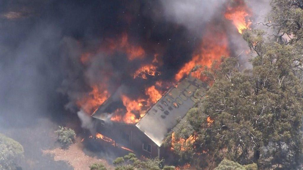 A house alight in the bushfire north of Perth