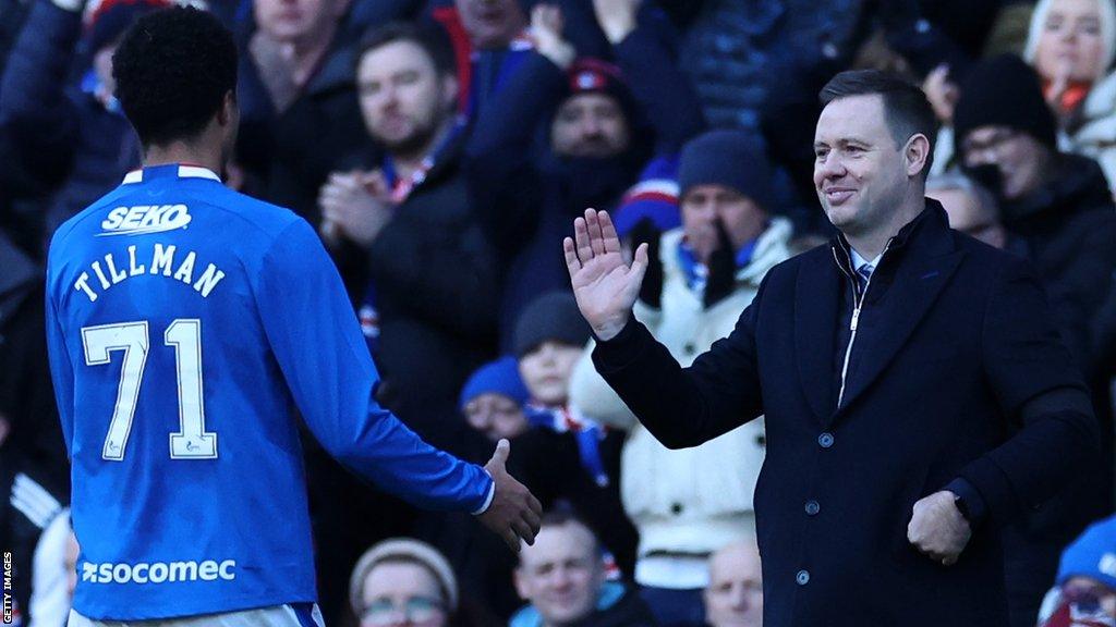 Mallik Tillman shakes hands with Michael Beale