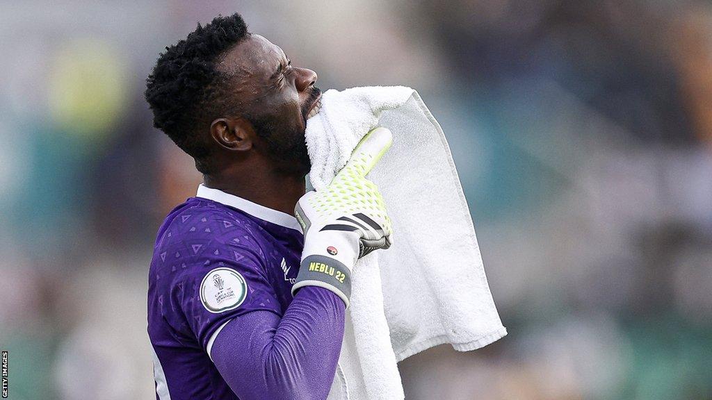 Angola goalkeeper Neblu bites a towel afer his red card against Namibia at the 2023 Africa Cup of Nations