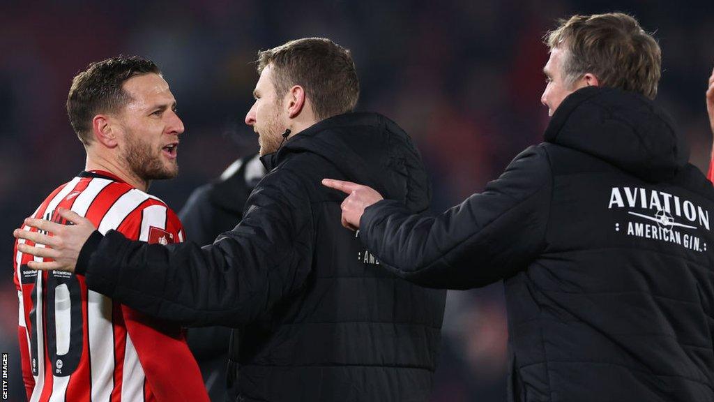 Billy Sharp (l), Paul Mullin (c) and Phil Parkinson (r) exchange words after full time at Bramall Lane