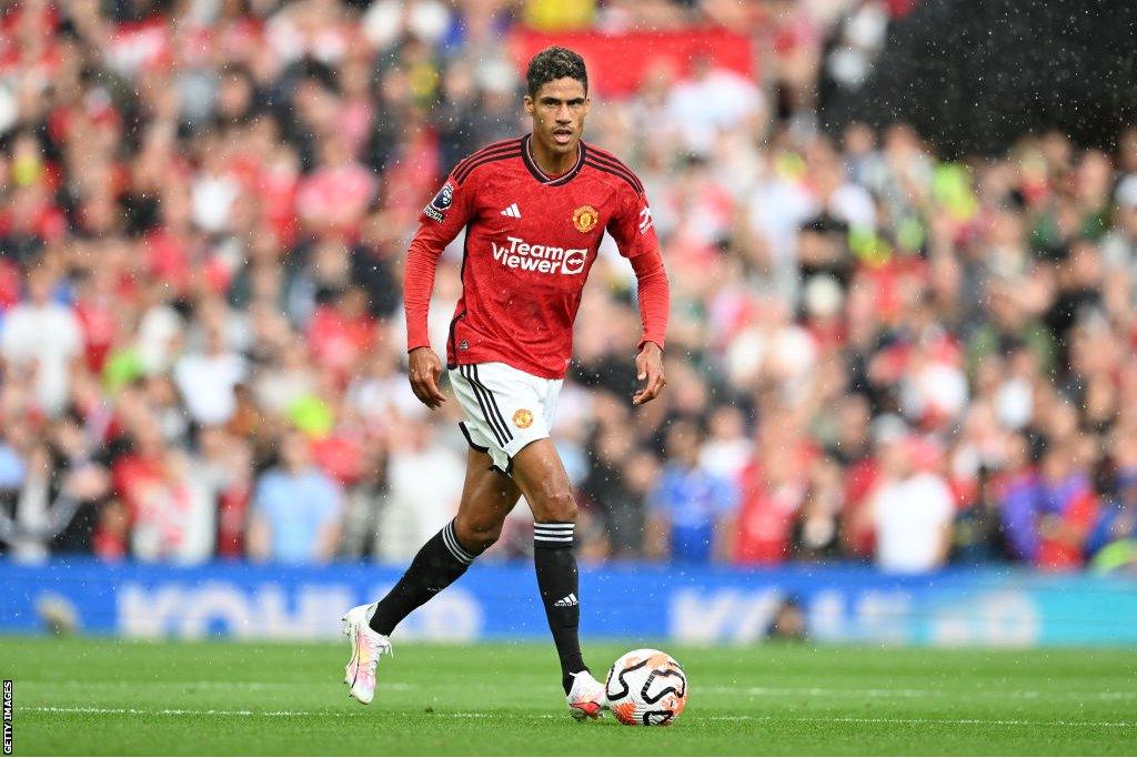 Raphael Varane runs with a football