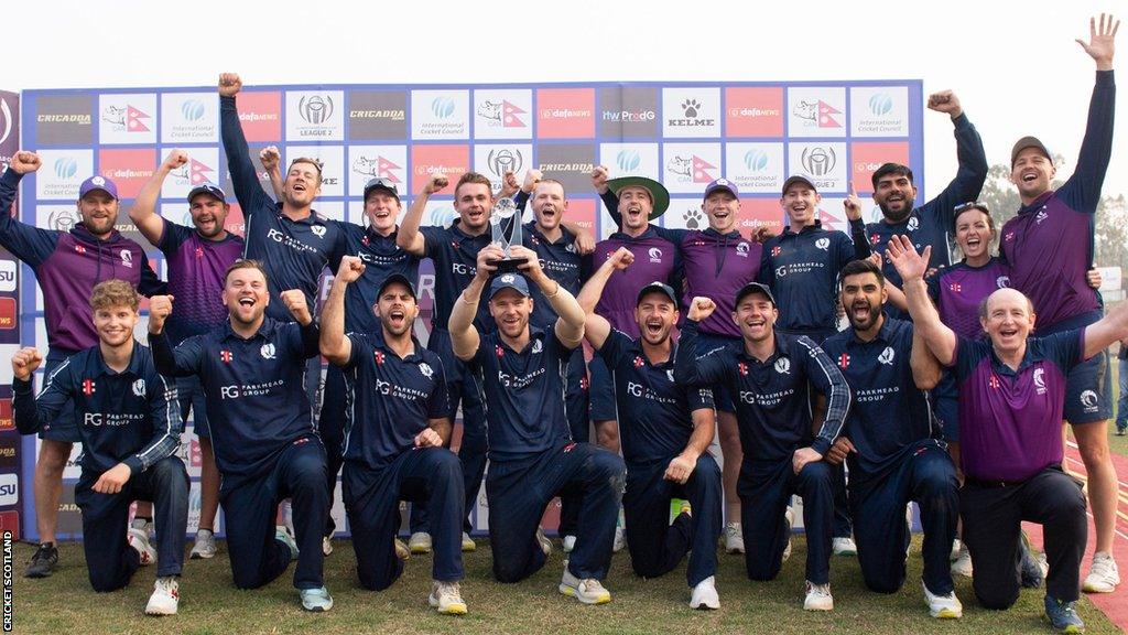 Scotland players and staff celebrate after being presented with the World Cup League 2 trophy