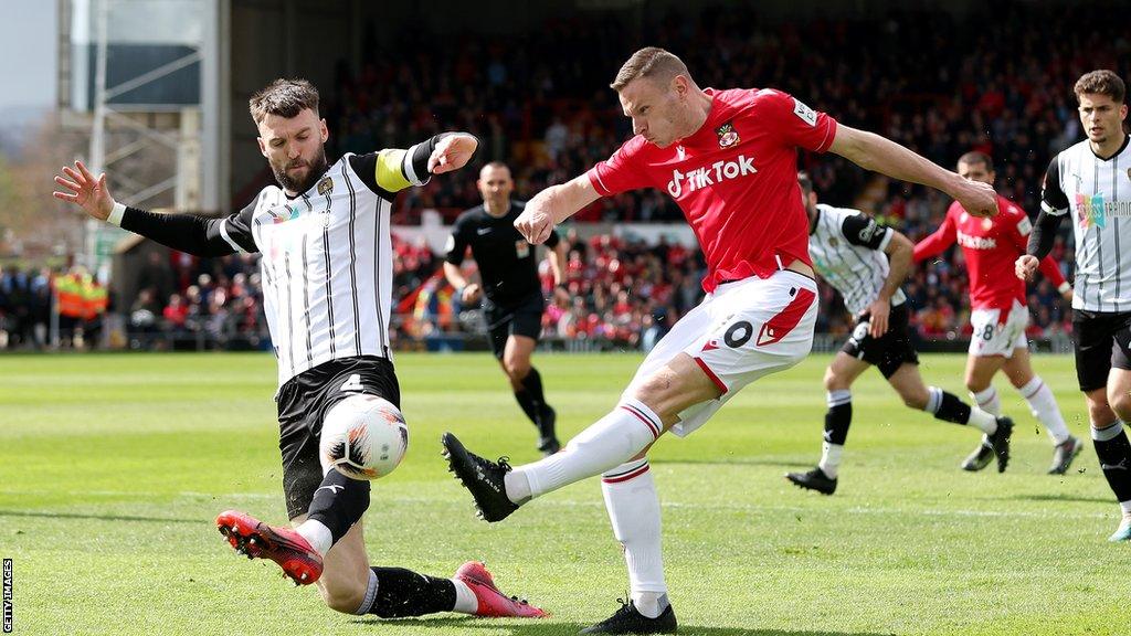 Wrexham striker Paul Mullin has a shot on goal against Notts County in April 2023