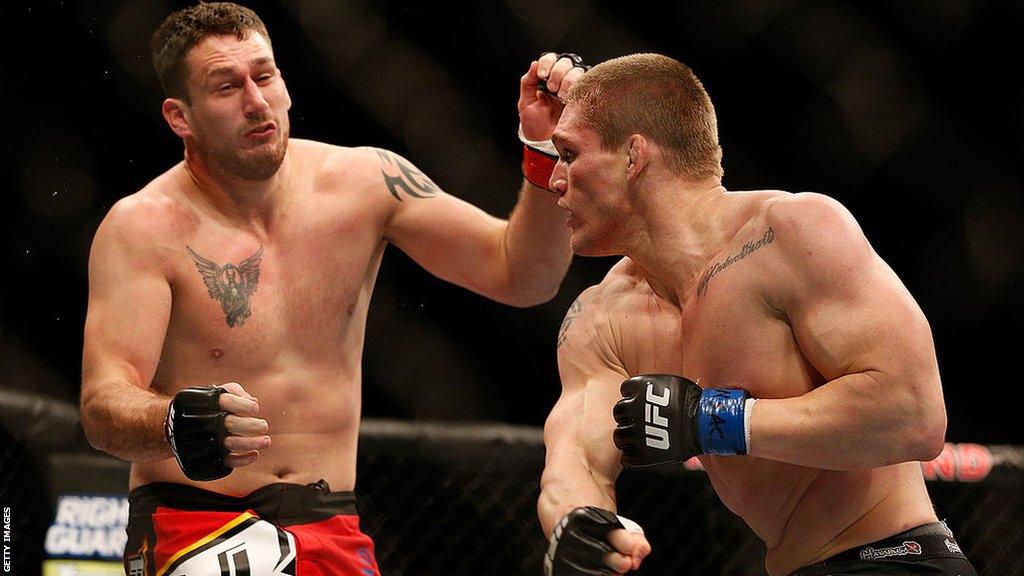 Phil De Fries (left) is punched by Todd Duffee