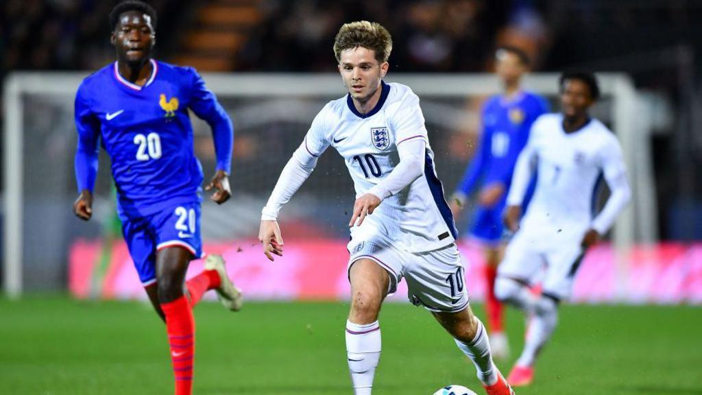 James McAtee running with the ball while playing for England Under-21s against France