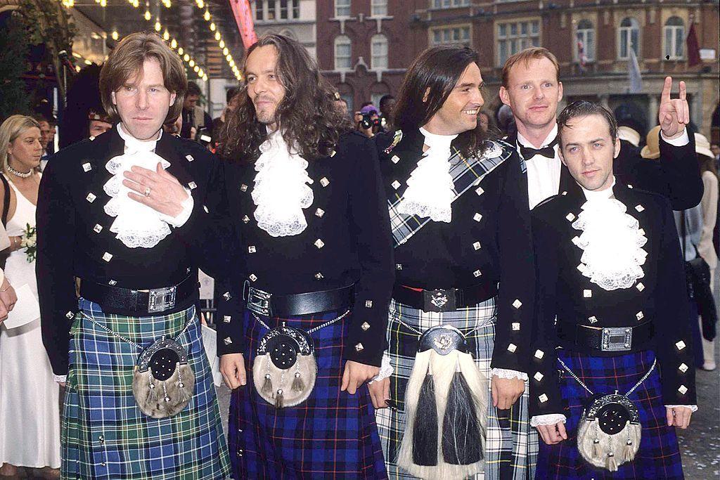 Marti Pellow - in his long hair era - and the rest of Wet Wet Wet pose in full kilt regalia including ruffle shirts and sporrans outside a cinema in London's Leicester Square in the early 90s