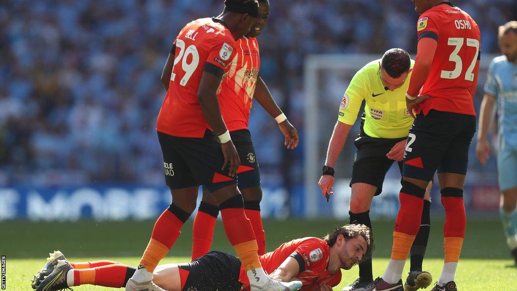 Tom Lockyer lies on the Wembley turf during last Saturday's Championship play-off final