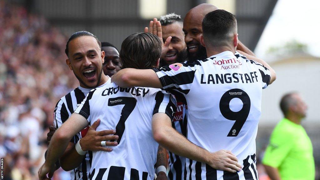 Notts County players celebrate scoring a goal against Accrington Stanley