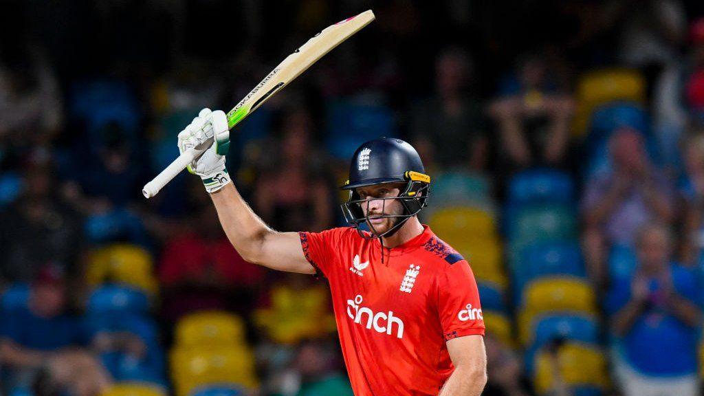 England captain Jos Buttler raises his bat after hitting fifty