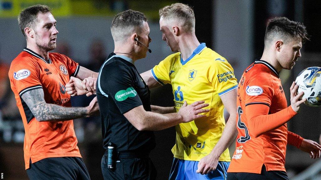 Referee John Beaton separates Dundee United's Kevin Holt and Raith Rovers' Ross Millen