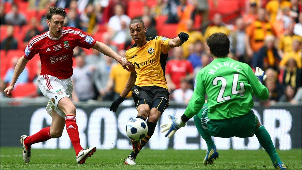 Christian Jolley of Newport County steers the ball past Daniel Davine of Wrexham for a goal during the Blue Square Bet Premier Conference play-off final match between Wrexham and Newport County at Wembley Stadium on May 5, 2013