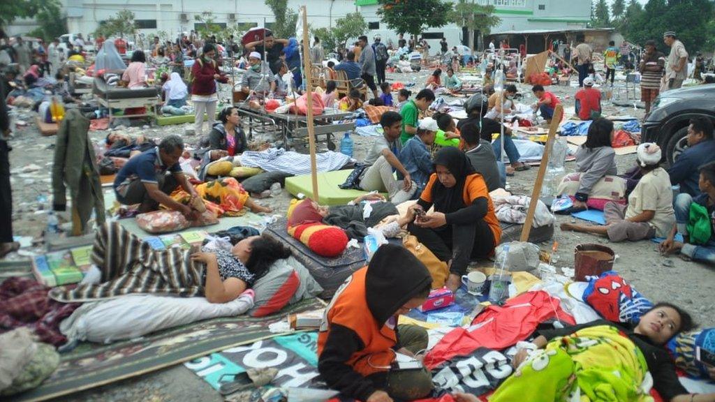 People sit outside a hospital in Palu. Photo: 29 September 2018