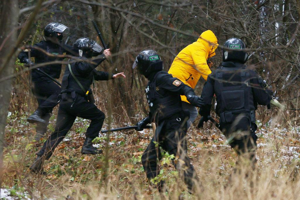 Police chase a demonstrator in Belarus on 22 November