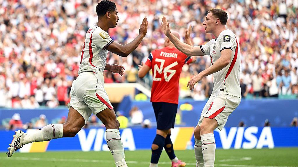 Jude Bellingham and Elliot Anderson high-five after the former's equaliser against Norway