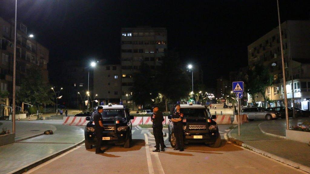 Security forces block the road in the city of Mitrovica near the Kosovo-Serbian border