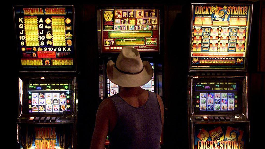 A man plays a slot machine 