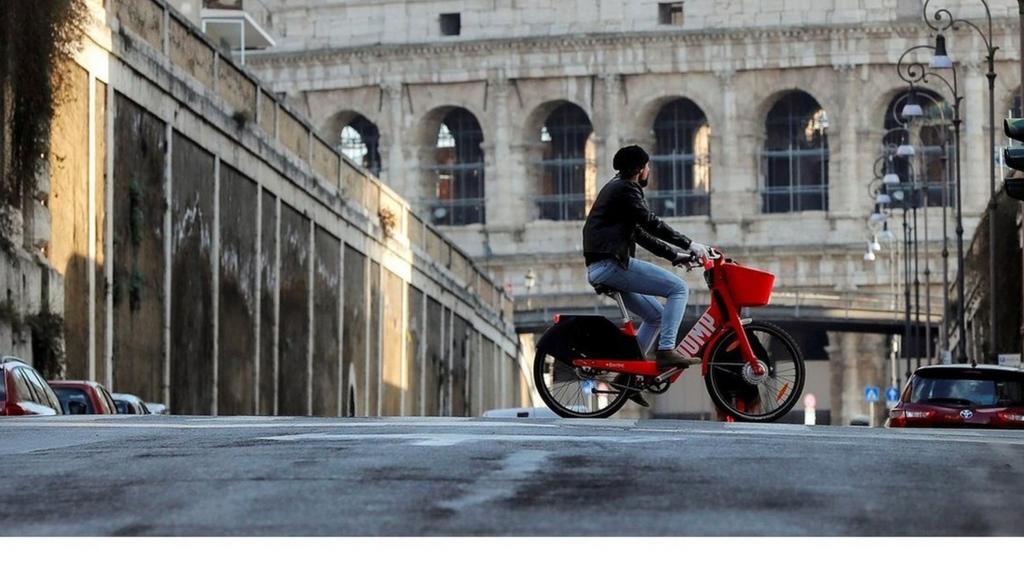 Cyclist in front of Colosseum in Rome