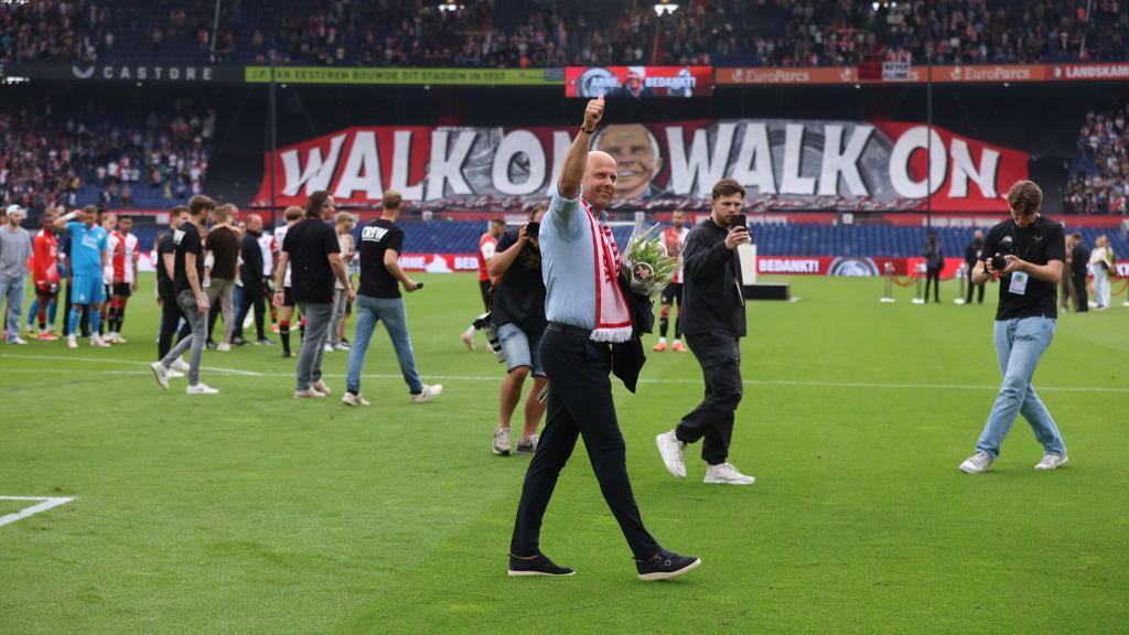 Arne Slot applauds the Feyenoord fans after leaving the club