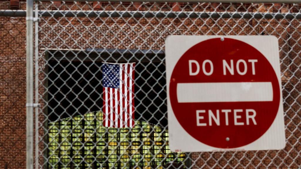 An American flag and a do not enter sign at the Kingsbridge Armory in the Bronx, New York, USA, on 21 April 2020