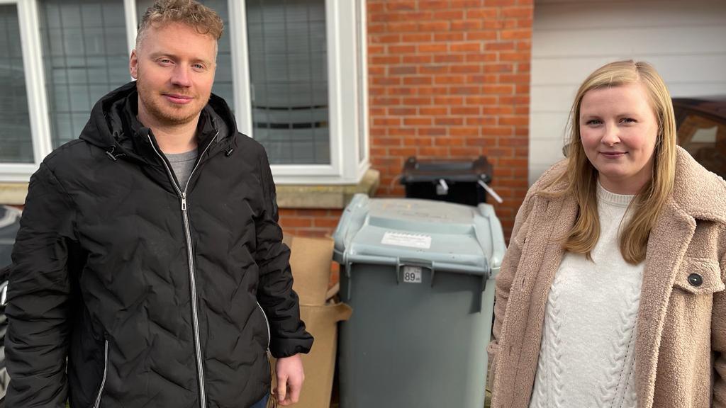 Tom and Hayley in front of their full bins