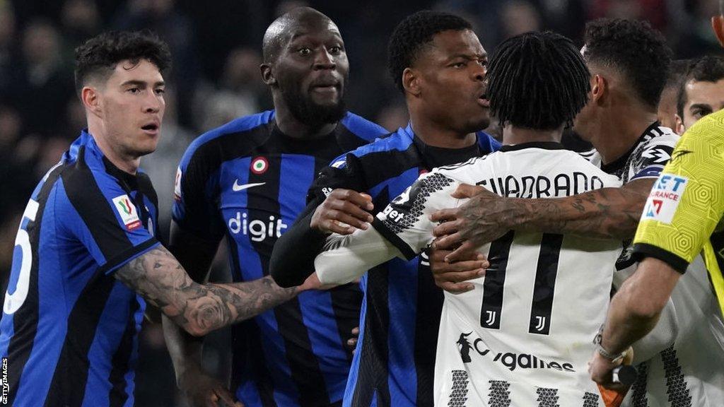 Romelu Lukaku is held back in front of Juventus players by his Inter Milan team-mate