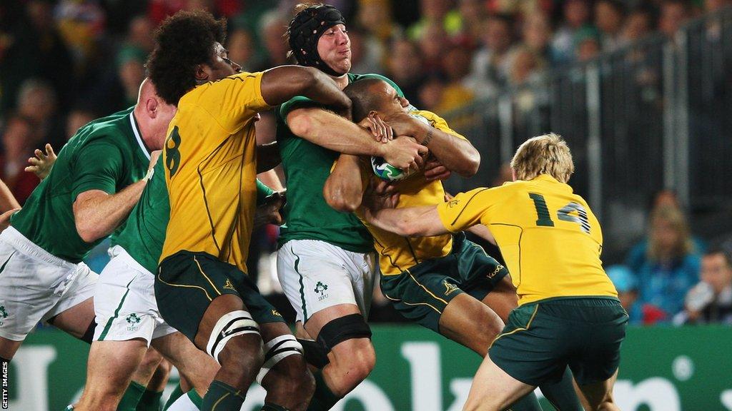 Stephen Ferris tackles Will Genia of Australia during the 2011 Rugby World Cup