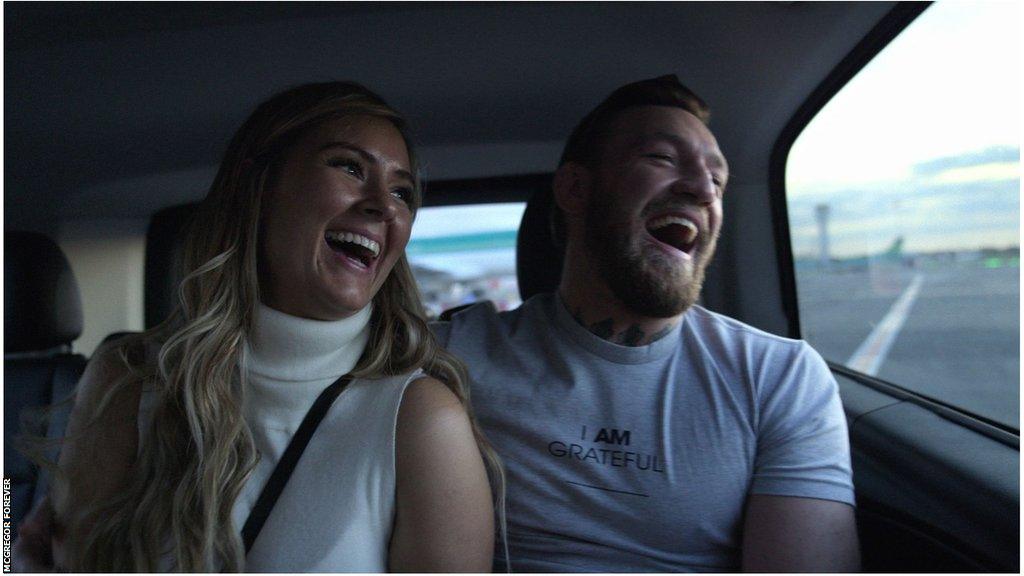 Dee Devlin and Conor McGregor laughing in the back of a car