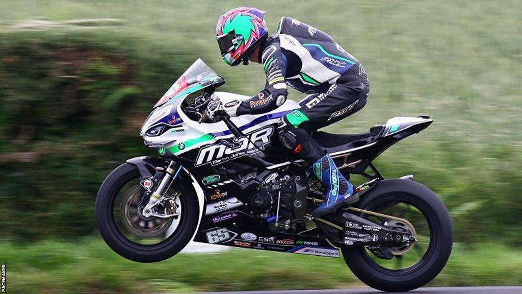 Michael Sweeney gets airborne while competing at the 2022 Armoy road races