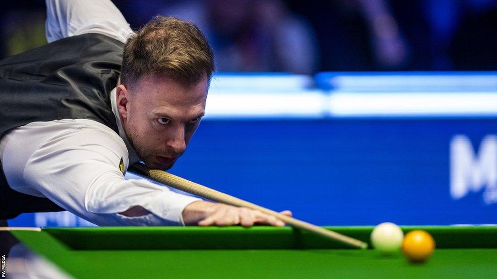 Judd Trump prepares to take a shot