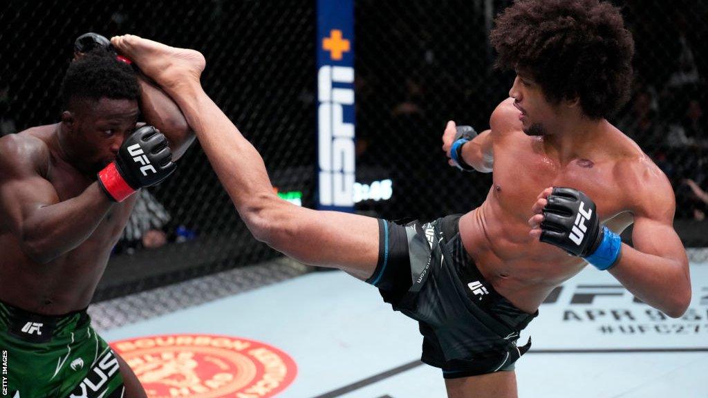 Alex Caceres aims a head kick at his opponent