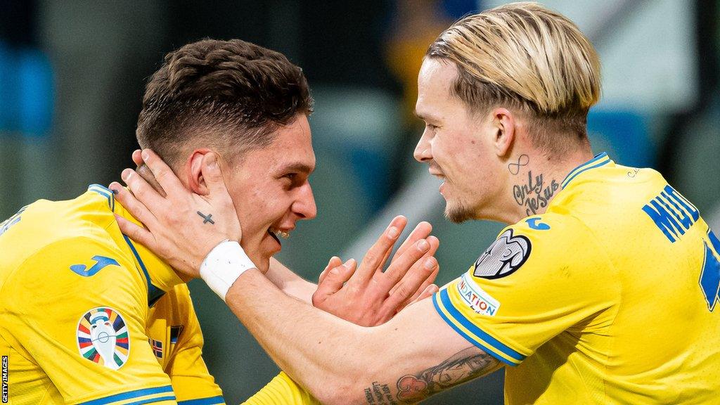 Ukraine players Georgiy Sudakov and Mykhailo Mudryk celebrate a goal against Iceland