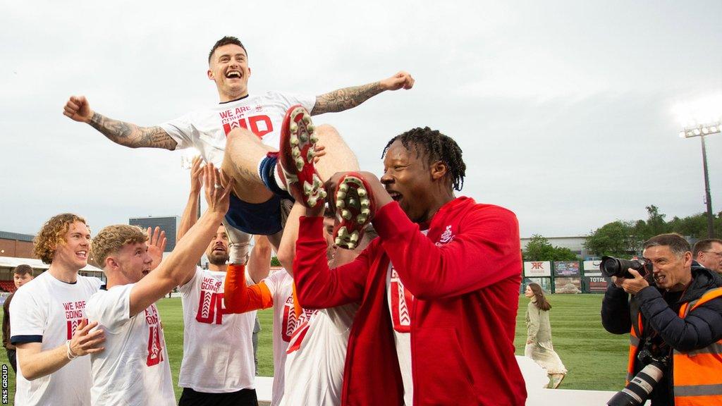 Rhys McCabe enjoys the celebrations after last season's play-off final victory