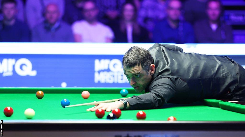 Ronnie O'Sullivan plays a shot