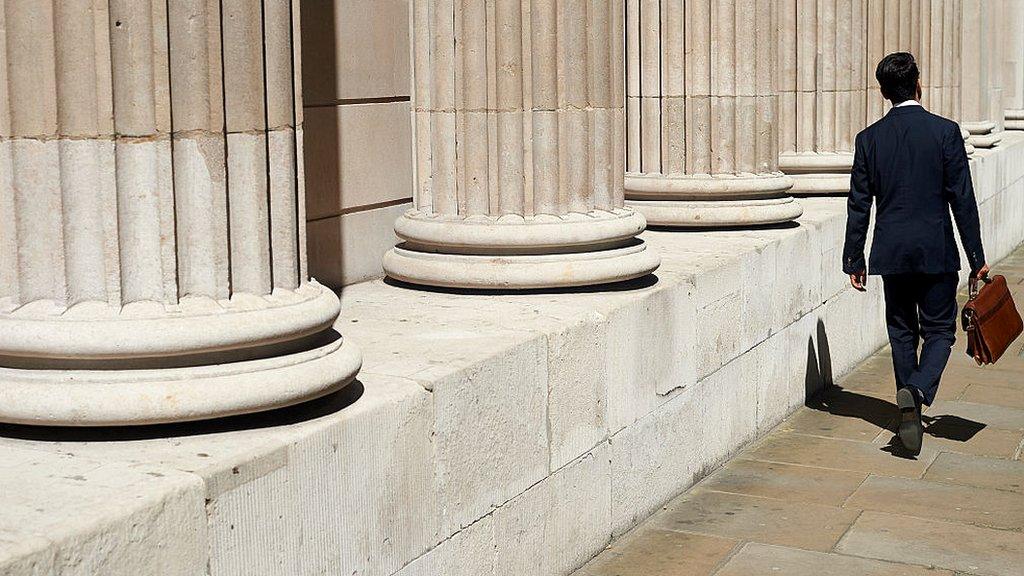 A pedestrian walks past the Bank of England (BOE) in the City of London on July 14, 2016