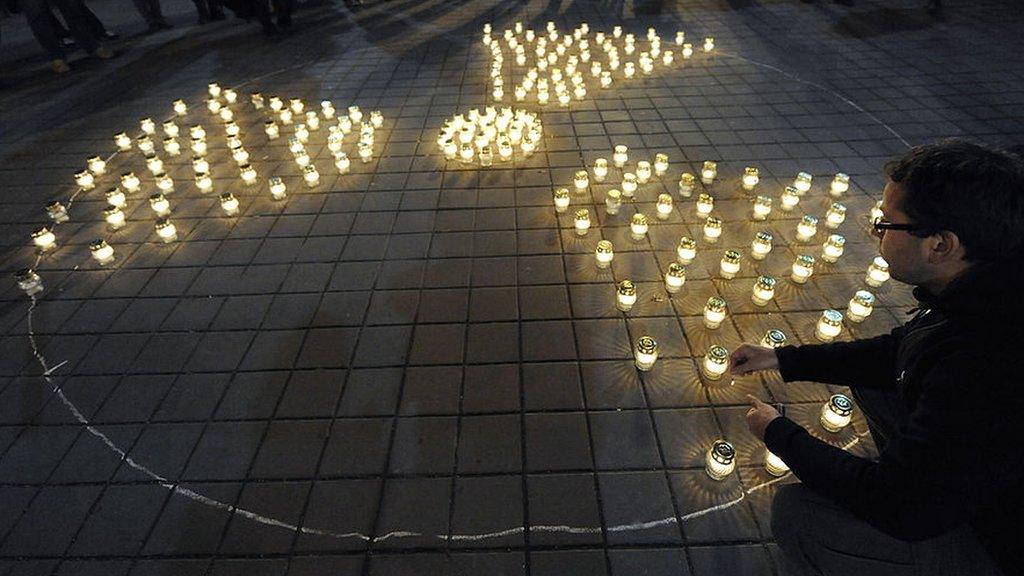 Lit candles form the radiation symbol