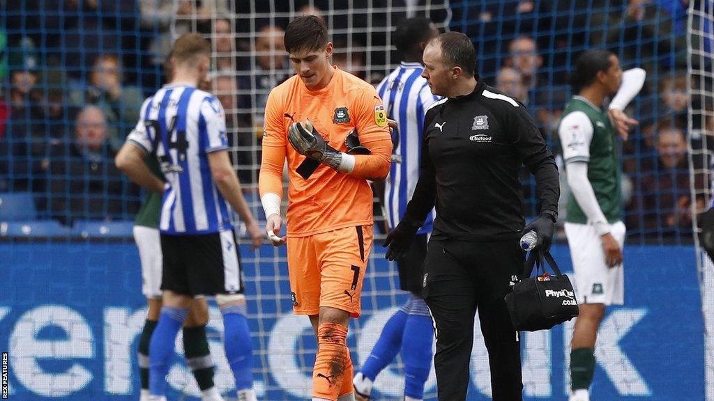 Michael Cooper goes off injured during Plymouth's defeat to Sheffield Wednesday