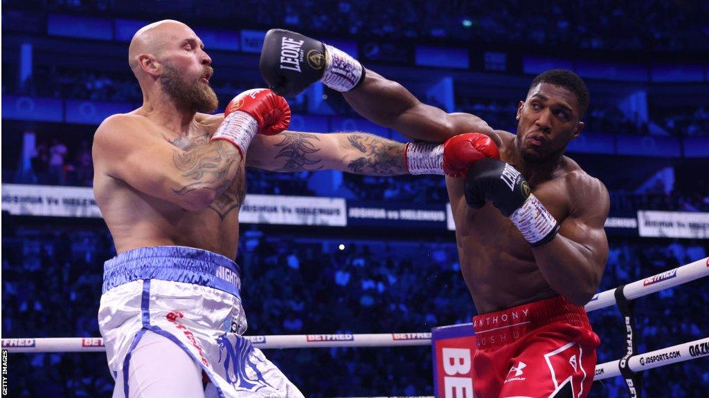 Anthony Joshua throws a right hand towards the head of Robert Helenius