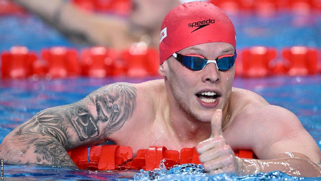 Swimmer Matt Richards performs a thumbs up gesture