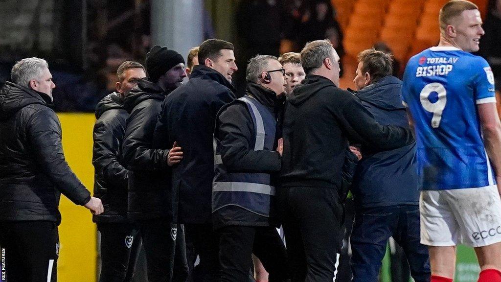 Port Vale fan held back by security