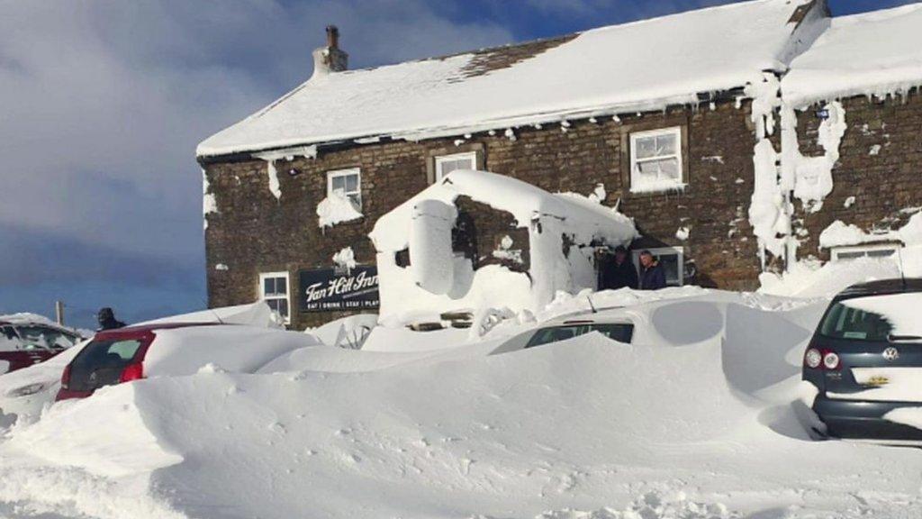 The Tan Hill Inn pub covered in snow