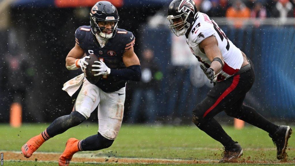 Chicago Bears quarterback Justin Fields runs with the ball