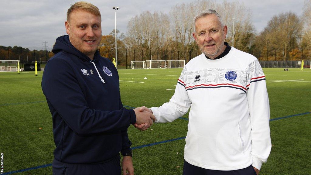 Ross McNeilly (left), pictured with Aldershot's head of football operations Terry Brown, has overseen four clean sheets in eight games as interim boss