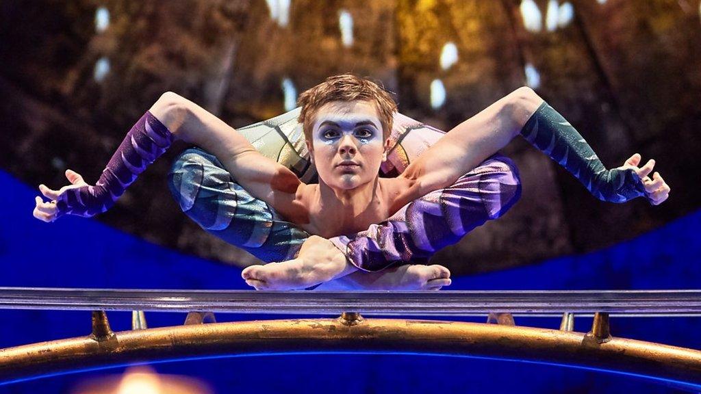 Aleksei Goloborodko in a contorted position in the show Luzia