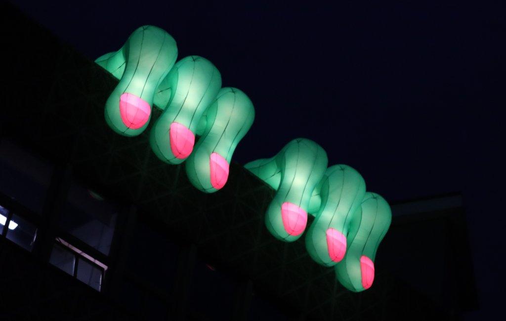 Glowing hands over top of building