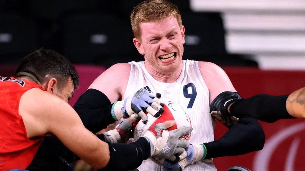 Britain's Jim Roberts (R) fights for the ball with Canada's Michael Whitehead (L)