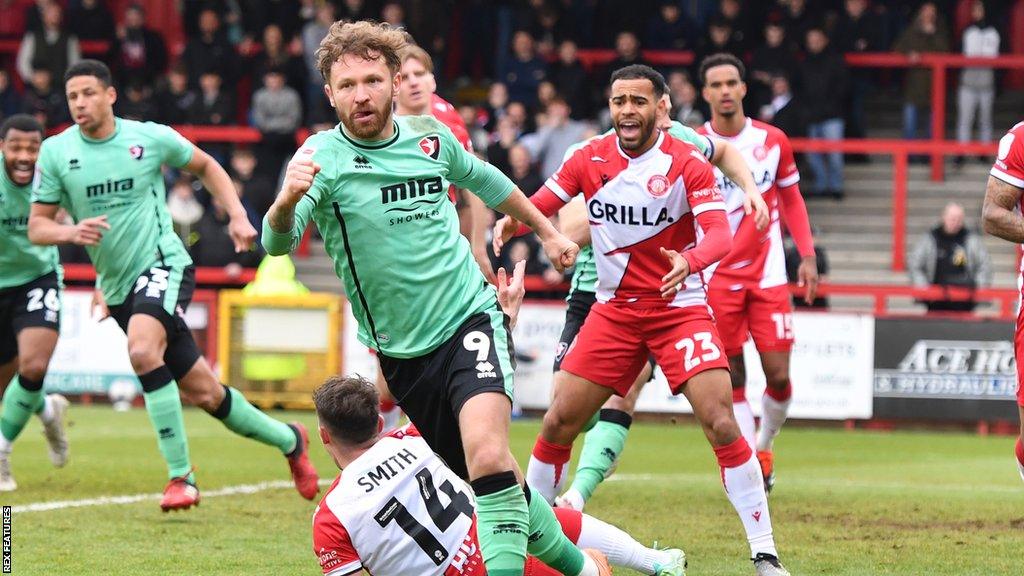 Matty Taylor celebrates his goal for Cheltenham against Stevenage