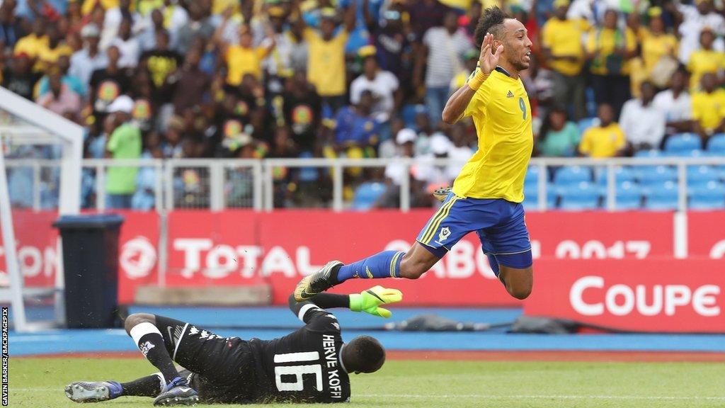 Pierre-Emerick Aubameyang flies through the air after a challenge by Burkina Faso goalkeeper Herve Koffi at the 2017 Africa Cup of Nations