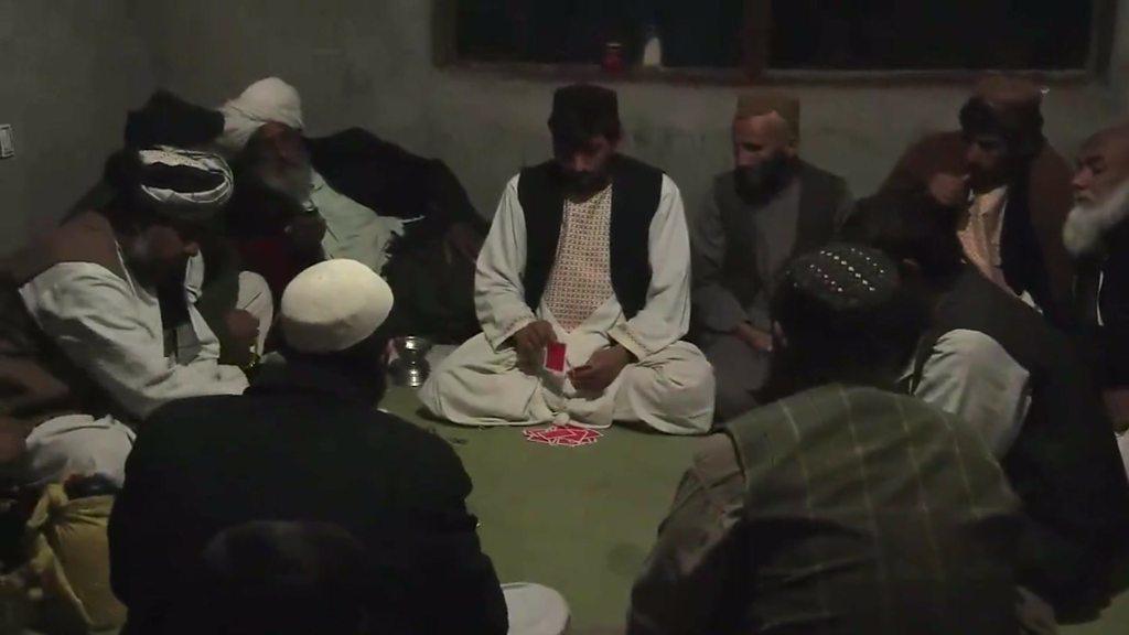 Men playing cards in Afghanistan's Helmand Province