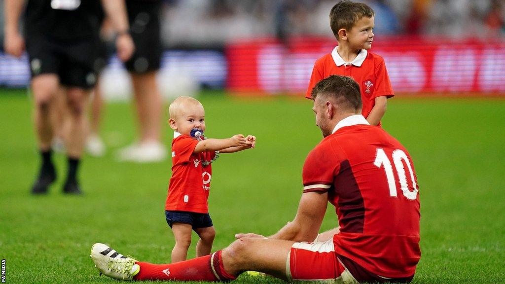 Wales fly-half Dan Biggar is joined by his children on the pitch after the Rugby World Cup 2023 quarter-final loss to Argentina