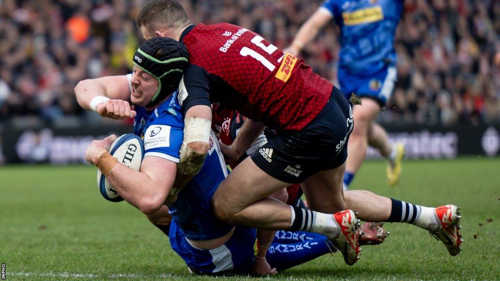 Jack Dunne goes over for Exeter's third try despite the tackle from Shane Daly